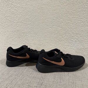 Women’s Nike Tanjun Black Sneakers with Metallic Accent